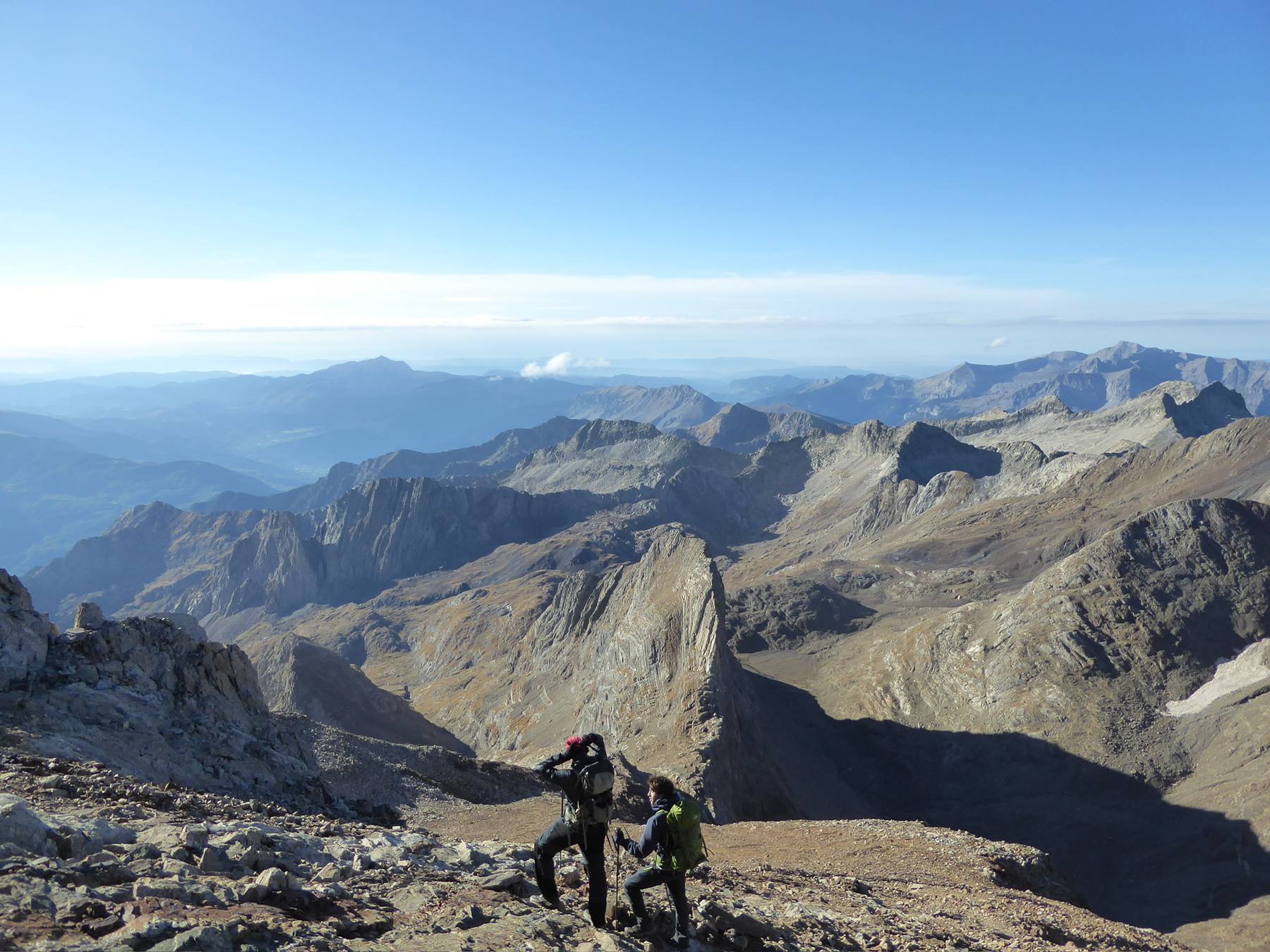 OCMT members scouting the route from a rocky summit