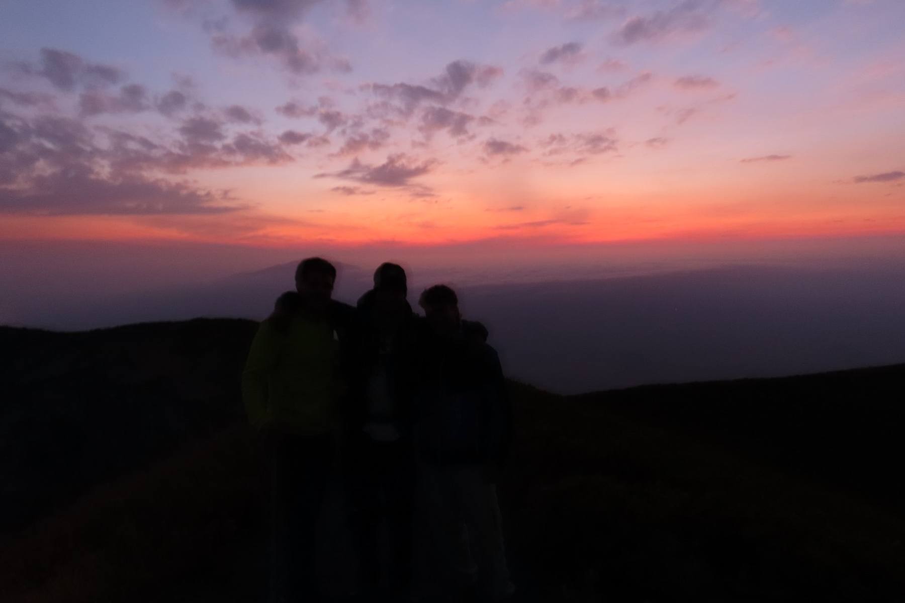 OCMT group silhouetted against a sunset on the ridge