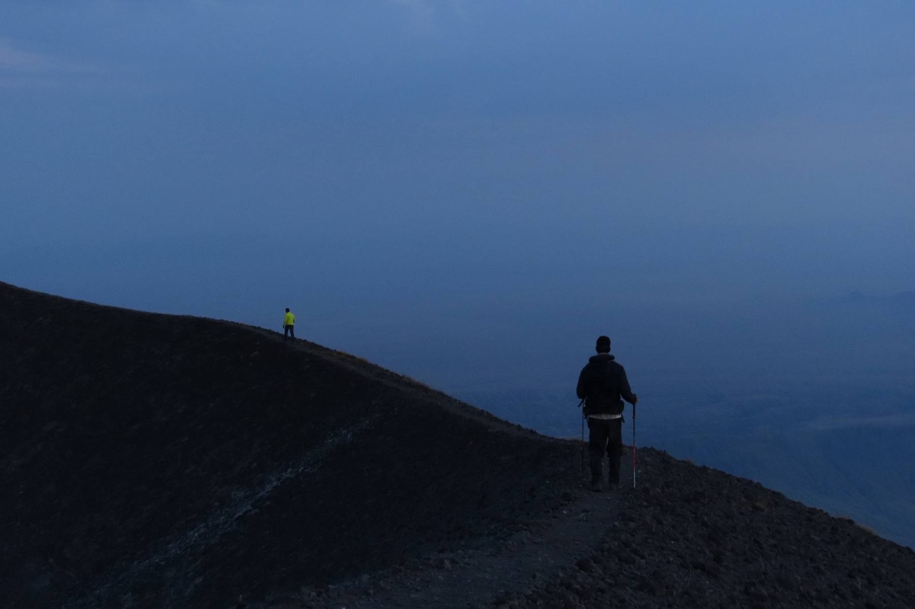 OCMT climbers silhouetted on a ridge at dusk